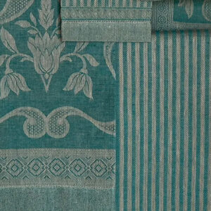 Close-up of jade green linen towels combining striped Iris Rustica and floral Damasco Rustica designs.