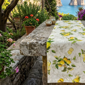 Limoncello linen table runner on an old stone table overlooking the Mediterranean