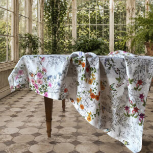 Gravure floral linen tablecloth displayed on an antique table in a sunlit English conservatory