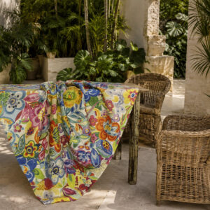Rio linen tablecloth with a colorful floral pattern on a table in a tropical veranda