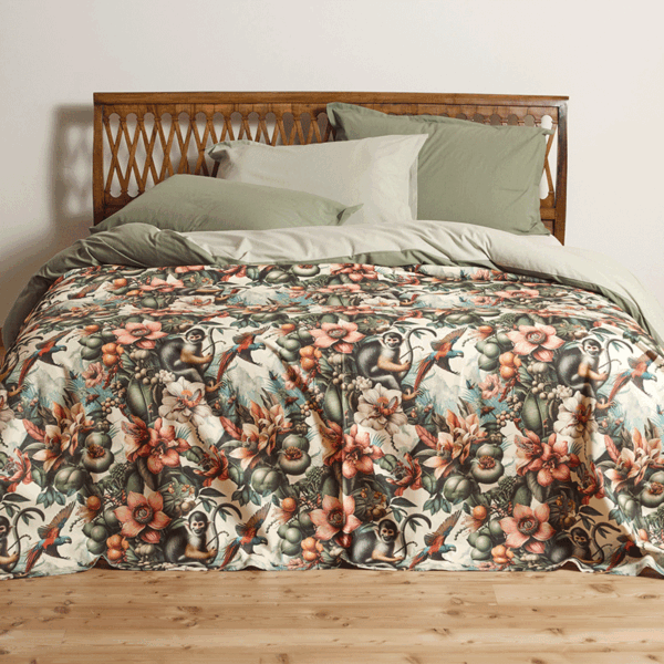 bedspread with a lively, tropical design featuring exotic flower patterns and playful monkeys