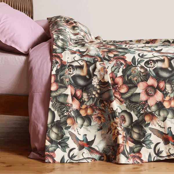 bedspread with a lively, tropical design featuring exotic flower patterns and playful monkeys