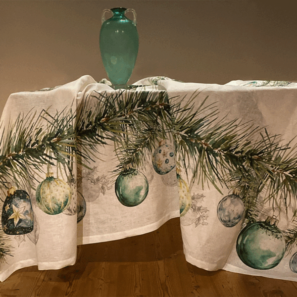 Christmas tablecloth in pure linen featuring an elegant print of pine branches and Christmas baubles in shades of green and gold