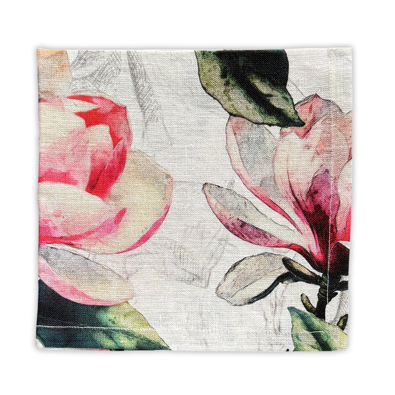 tovagliolo-magnolia-rosa-La-Bottega-di-Casa Magnolia Rosa linen napkin on white background — magnolia flowers in dusty pink and carmine with green foliage and grey sketched blooms on natural linen