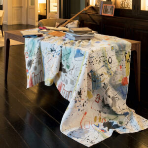 Contemporary linen tablecloth with abstract ink-inspired motifs and vibrant color accents