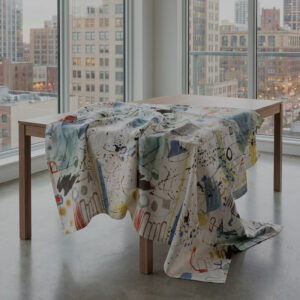 Contemporary linen tablecloth with abstract ink-inspired motifs and vibrant color accents