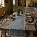 Blue Intersezioni hemp and Egyptian cotton table runner on a rustic dining table.