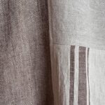 Light chocolate brown and natural herringbone linen fabrics of Follia Pura apron