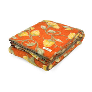Folded Narciso Orange boiled wool throw with raised yellow flowers and sage-green stems, finished with green edge stitching.