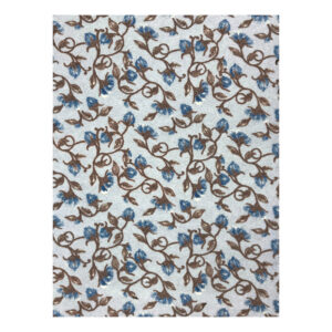 Narciso Blue throw shown flat, with blue daffodils, leaves, and curling brown stems across a pale blue background.